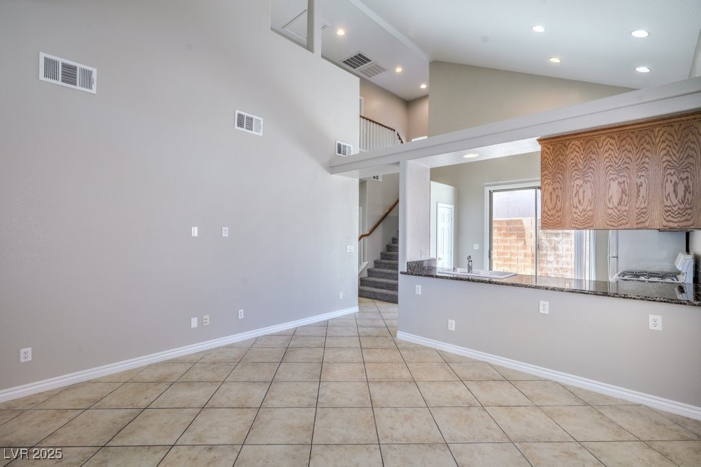 8121 Altamont Ridge Street Las Vegas, NV 89113 - Photo 7 of 27 Unfurnished living room featuring high vaulted cei