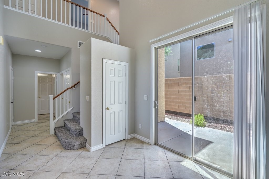 8121 Altamont Ridge Street Las Vegas, NV 89113 - Photo 8 of 27 Foyer featuring light tile patterned floors, stair