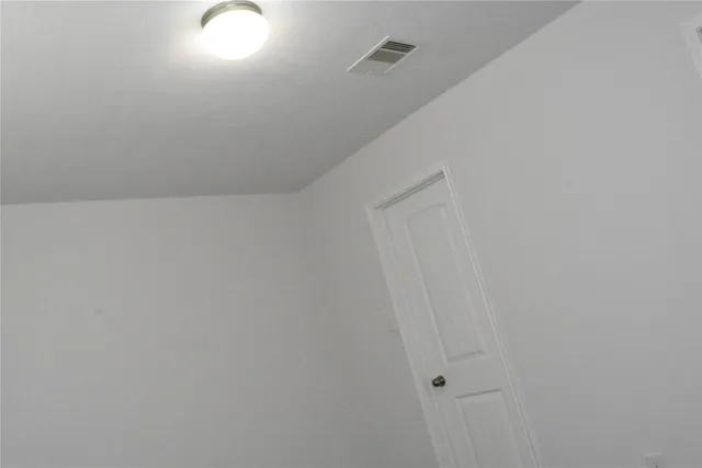 an empty room with wooden floor and a window