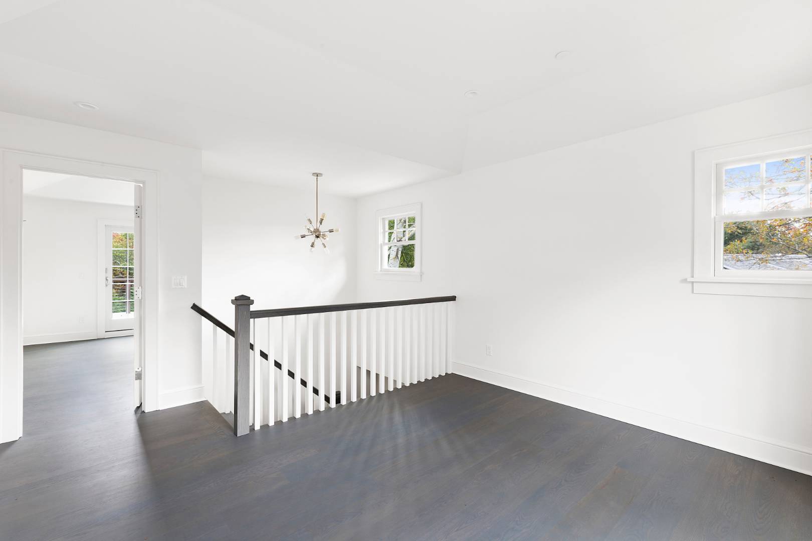 12 Inkberry Street East Hampton, NY 11937 - Photo 11 of 25 a view of a hallway with wooden floor and windows