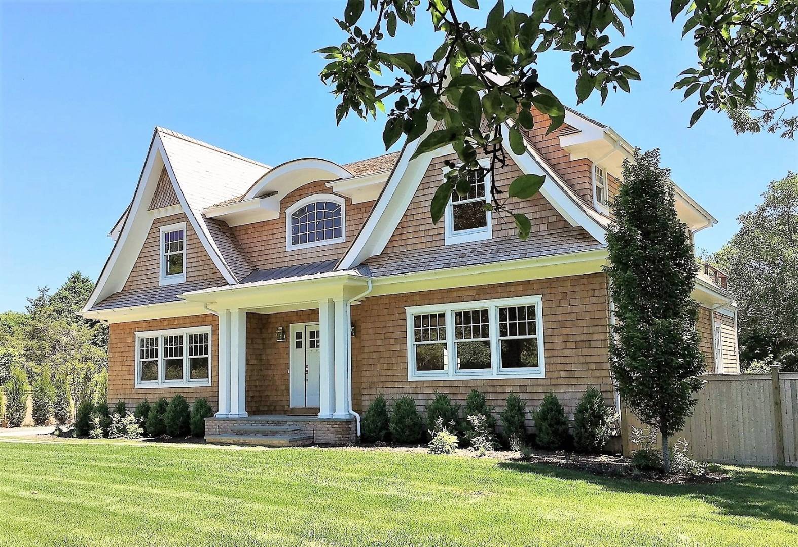 12 Inkberry Street East Hampton, NY 11937 - Photo 23 of 25 a front view of a house with a yard