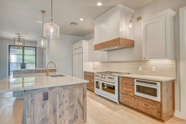 a view of an empty room with a fireplace and a window