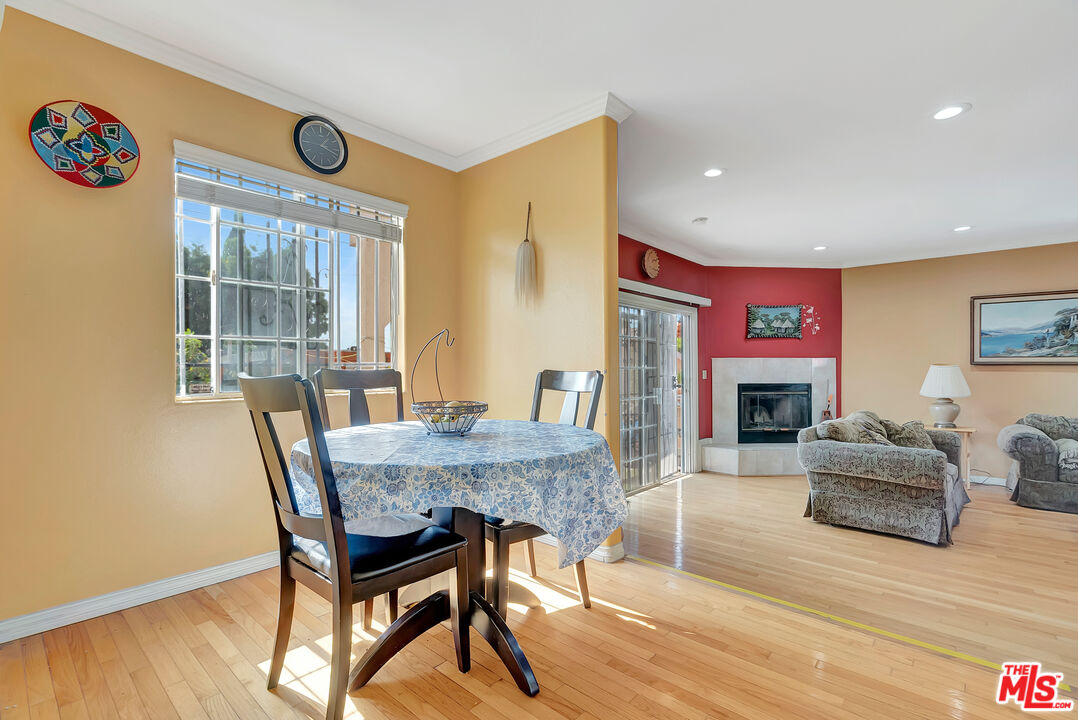 448 West 64th Street Inglewood, CA 90302 - Photo 11 of 39 a dining room with furniture a fireplace and wooden floor