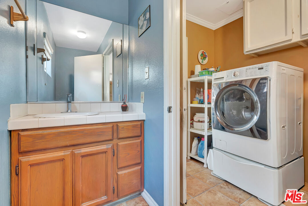 448 West 64th Street Inglewood, CA 90302 - Photo 16 of 39 a bathroom with a sink and a mirror