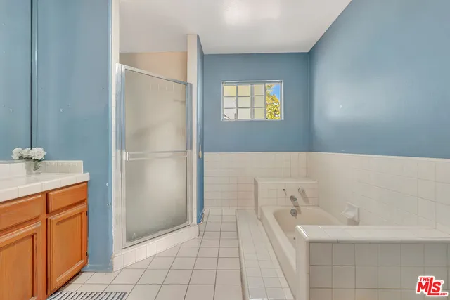 a bathroom with a tub sink and mirror