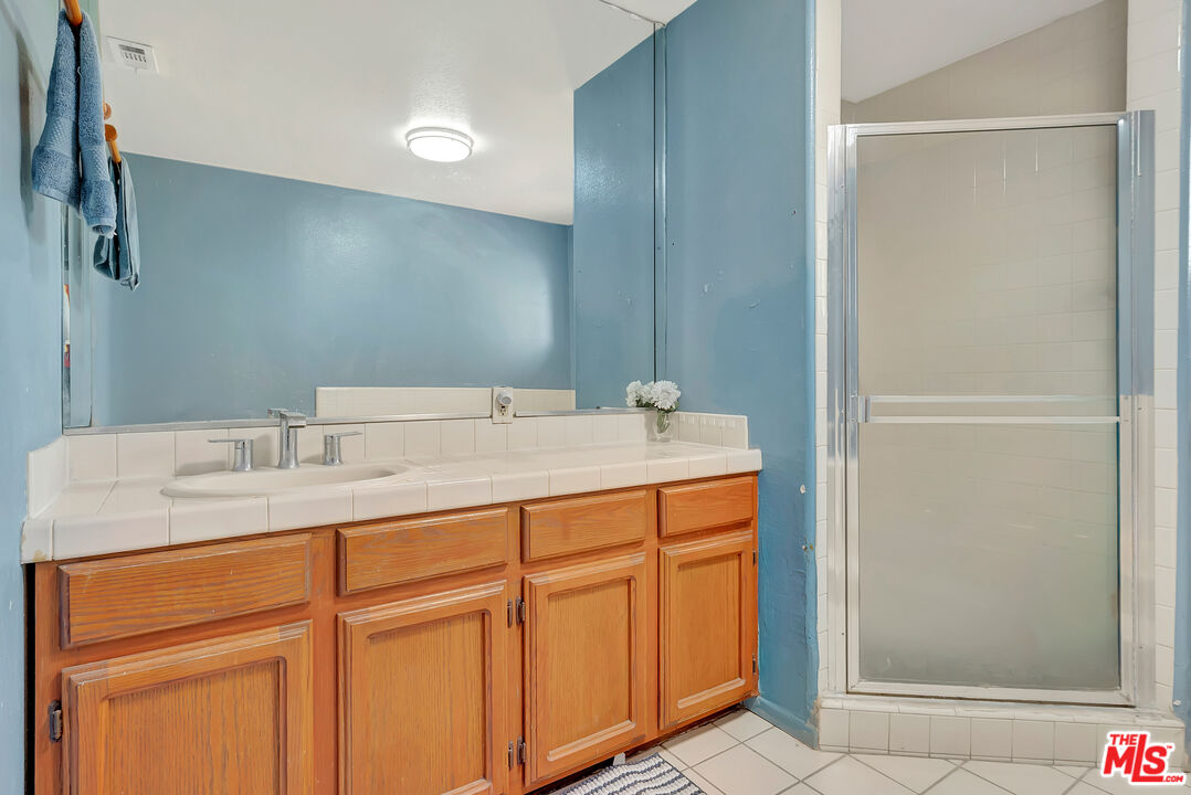 448 West 64th Street Inglewood, CA 90302 - Photo 23 of 39 a bathroom with a sink and a mirror