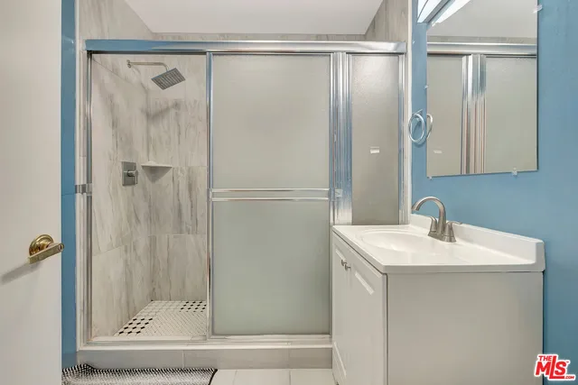 a bathroom with a shower and a sink
