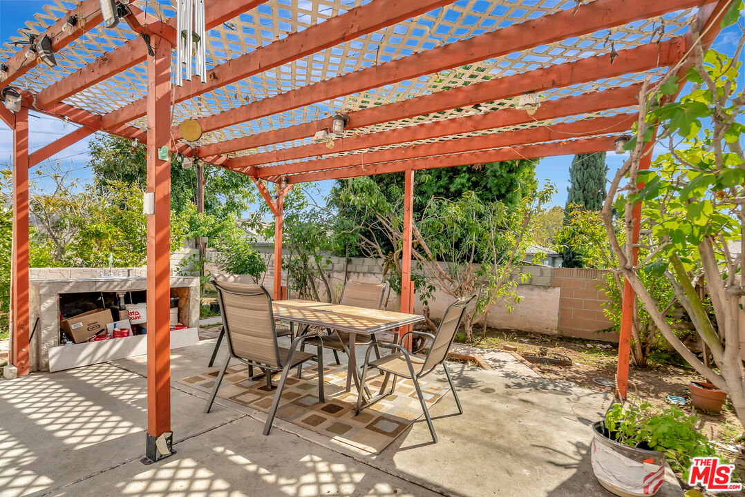 448 West 64th Street Inglewood, CA 90302 - Photo 30 of 39 a patio with table and chairs and potted plants