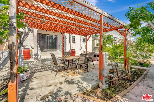 a view of a patio with table and chairs and potted plants