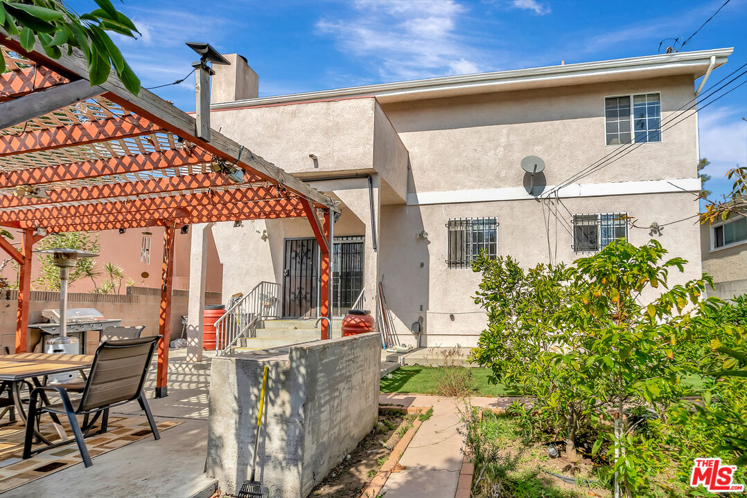 448 West 64th Street Inglewood, CA 90302 - Photo 32 of 39 a view of a patio with table and chairs and potted plants