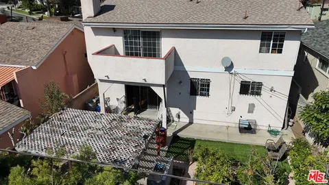 an aerial view of multiple houses with outdoor space