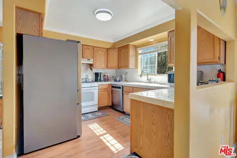a kitchen with a sink window and cabinets