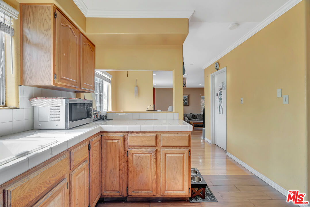 448 West 64th Street Inglewood, CA 90302 - Photo 9 of 39 a kitchen with granite countertop a sink and a stove top oven
