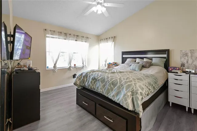 a bed room with a bed and a flat tv screen on a dresser