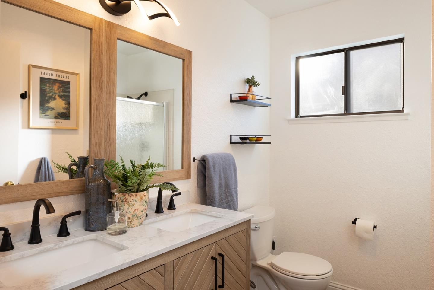 3850 Rio Road, Unit 63 Carmel, CA 93923 - Photo 14 of 19 a bathroom with a granite countertop sink mirror vanity and toilet