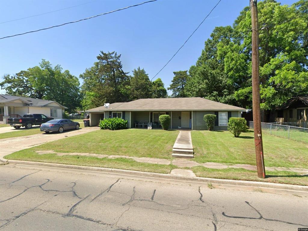 a view of a yard with a table and plants