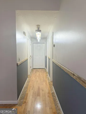 a view of a room with wooden floor