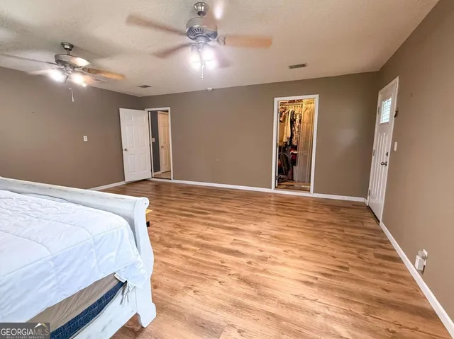 a bedroom with a large bed and a chandelier