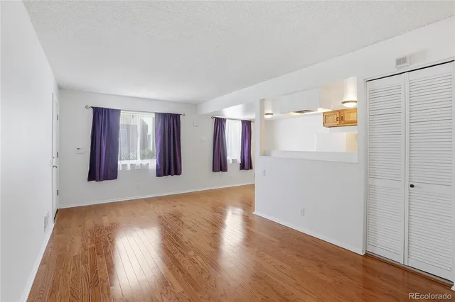 a view of a livingroom with wooden floor and a window