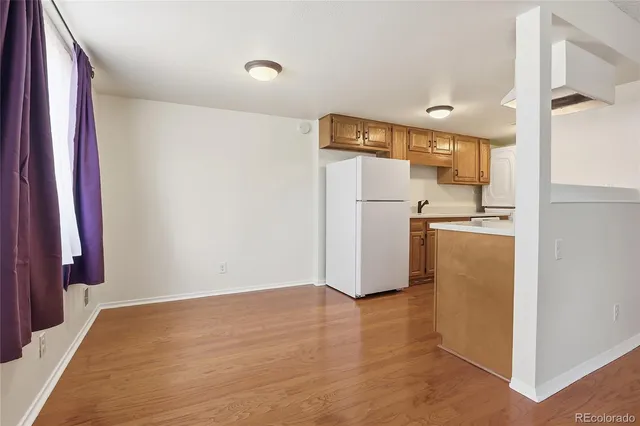 a view of a kitchen with a refrigerator a stove top oven and a refrigerator