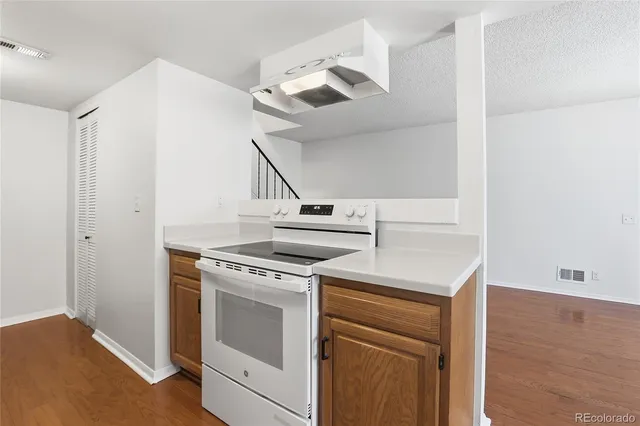 a view of a kitchen with stove top oven