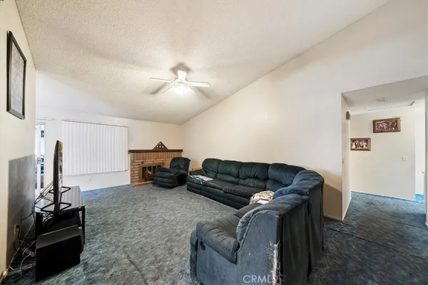 an empty room with chandelier fan