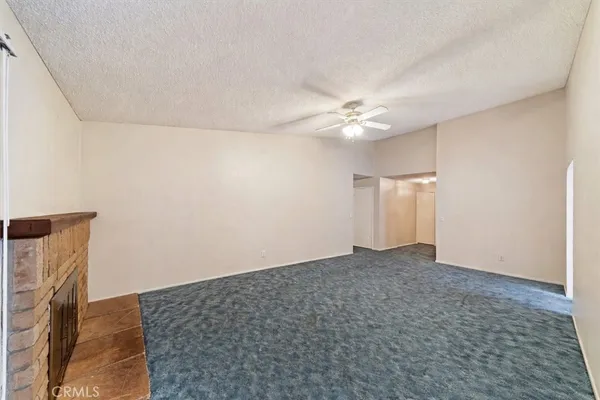 a living room with furniture a flat screen tv and a window