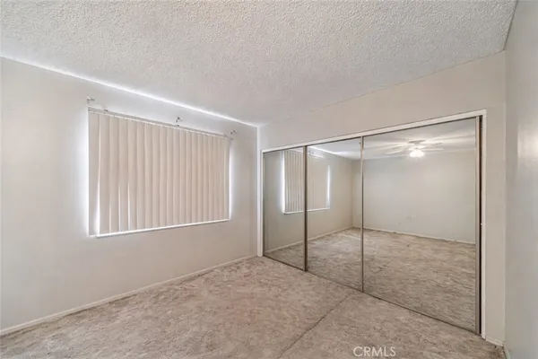 an empty room with fan and entrance