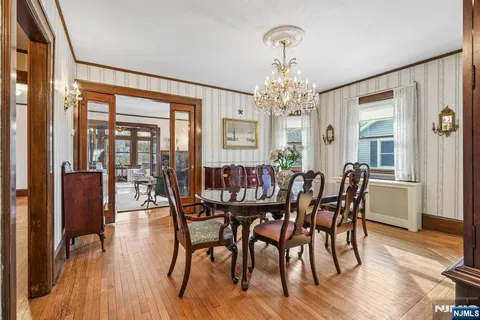 a kitchen with stainless steel appliances kitchen island granite countertop a table chairs and a refrigerator