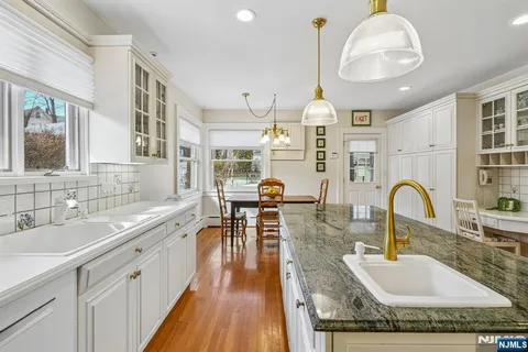 a room with furniture a chandelier and pool table