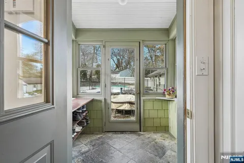 a living room with furniture a flat screen tv and a garden