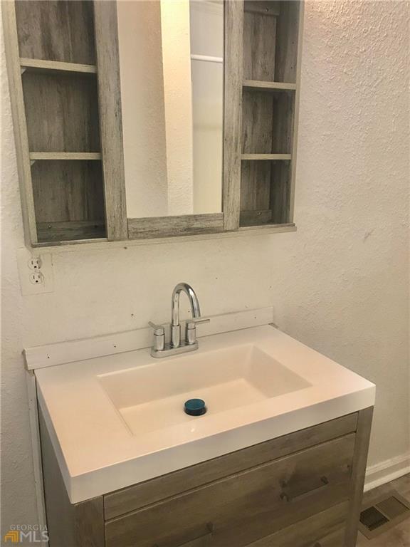 116 Edwards Street Bremen, GA 30110 - Photo 22 of 33 a bathroom with a sink and a mirror
