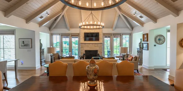 a living room with fireplace furniture and a chandelier