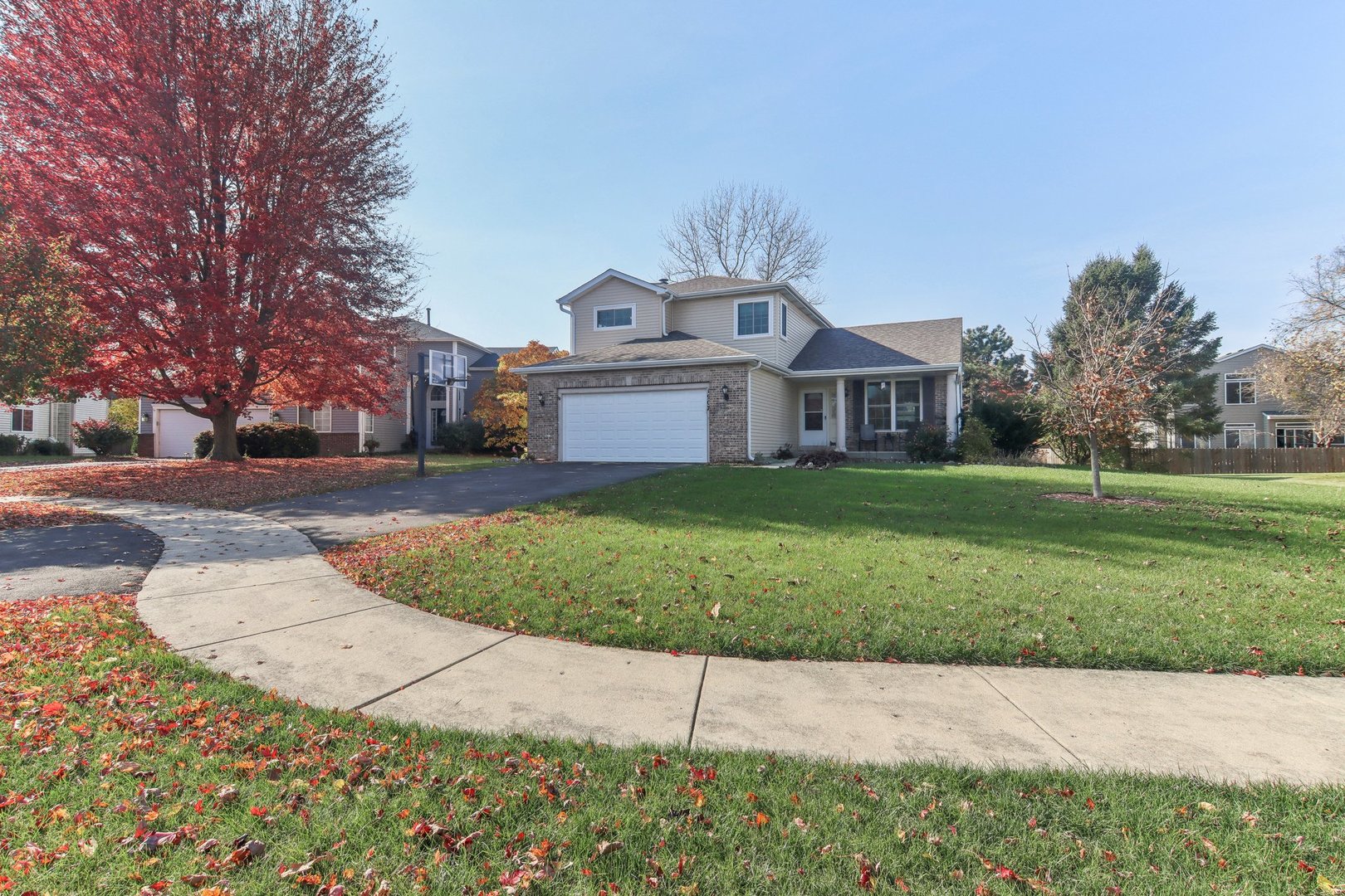 1907 Apple Valley Road Bolingbrook, IL 60490 - Photo 1 of 4 a front view of a house with a yard and garage
