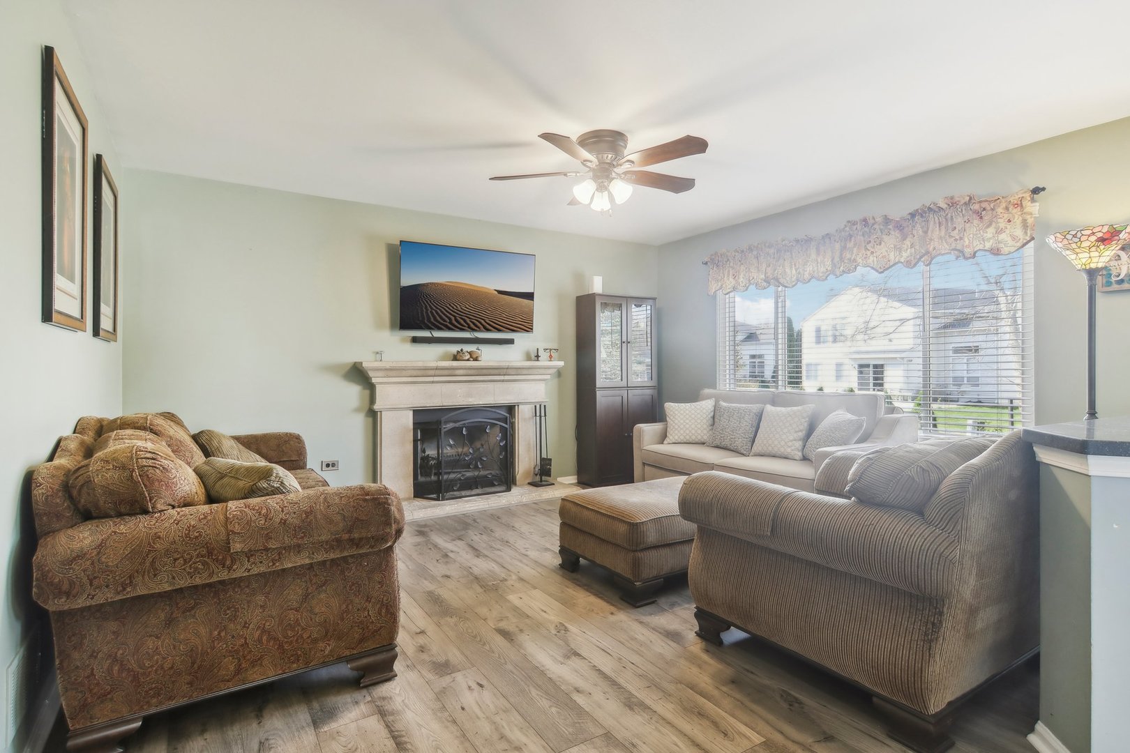 1907 Apple Valley Road Bolingbrook, IL 60490 - Photo 2 of 17 a living room with furniture a fireplace and a flat screen tv