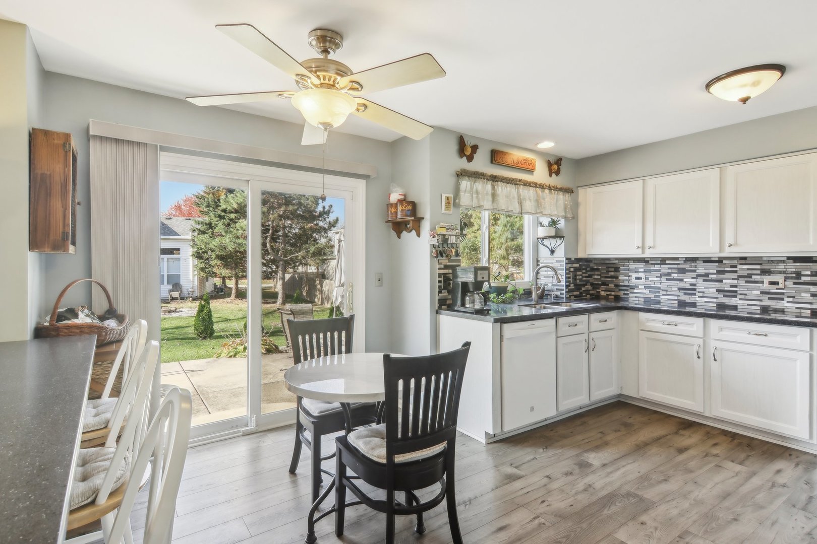 1907 Apple Valley Road Bolingbrook, IL 60490 - Photo 4 of 17 a kitchen with a dining table chairs stainless steel appliances and cabinets
