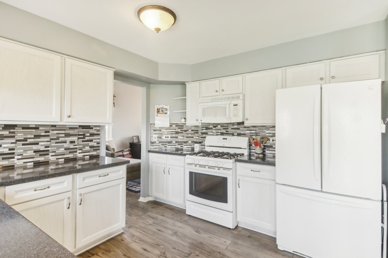 1907 Apple Valley Road Bolingbrook, IL 60490 - Photo 5 of 17 a kitchen with white cabinets and white appliances