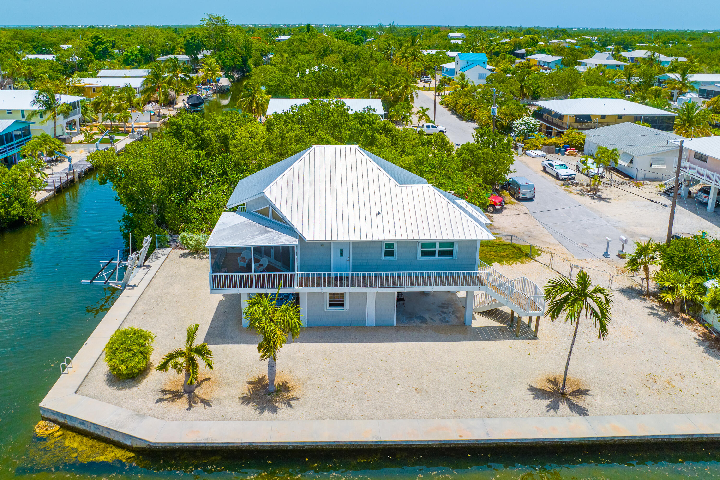 an aerial view of a house with a yard and lake view