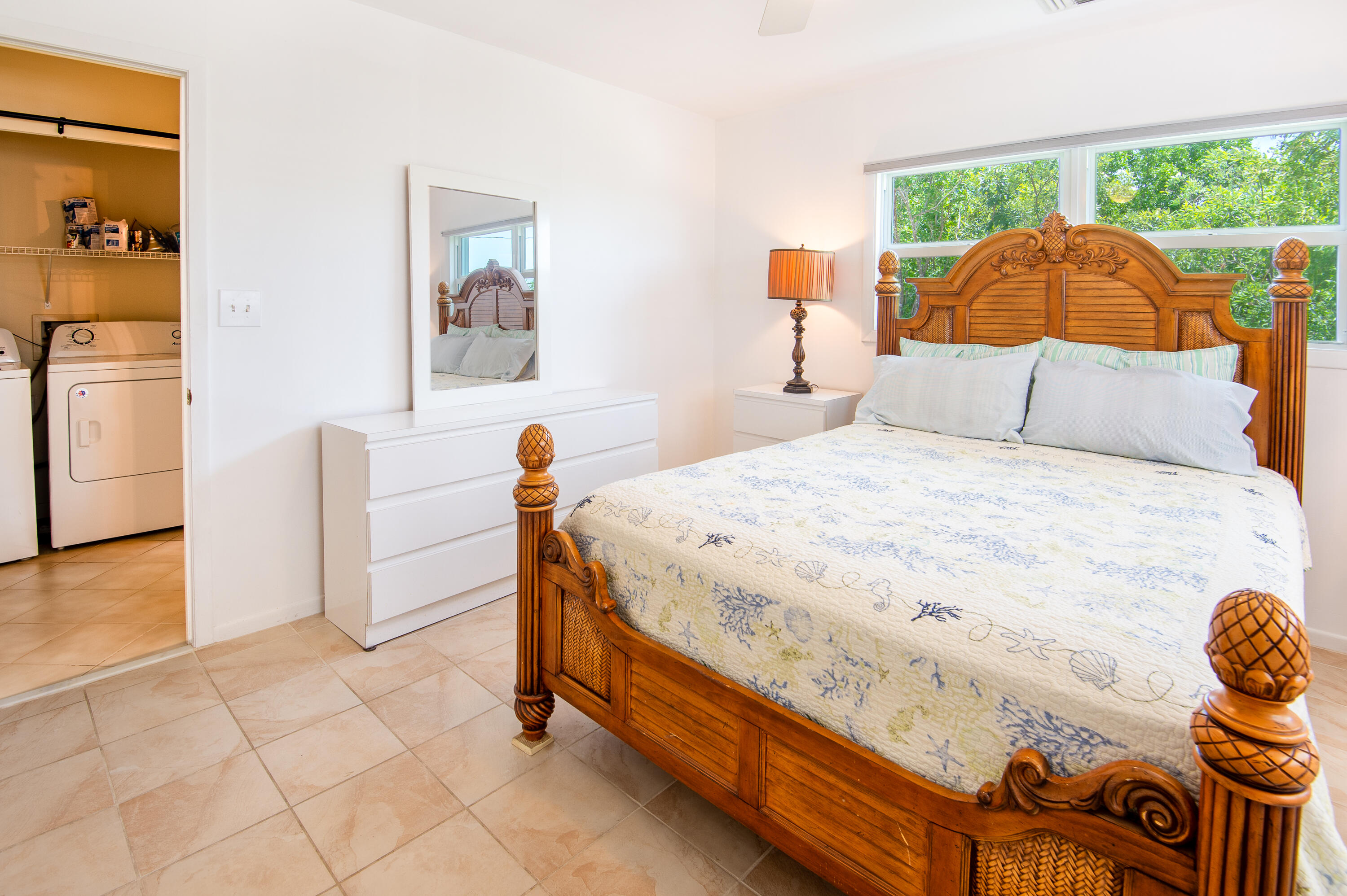 29015 Cedar Drive Big Pine Key, FL 33043 - Photo 20 of 38 a bedroom with a bed and wooden floor