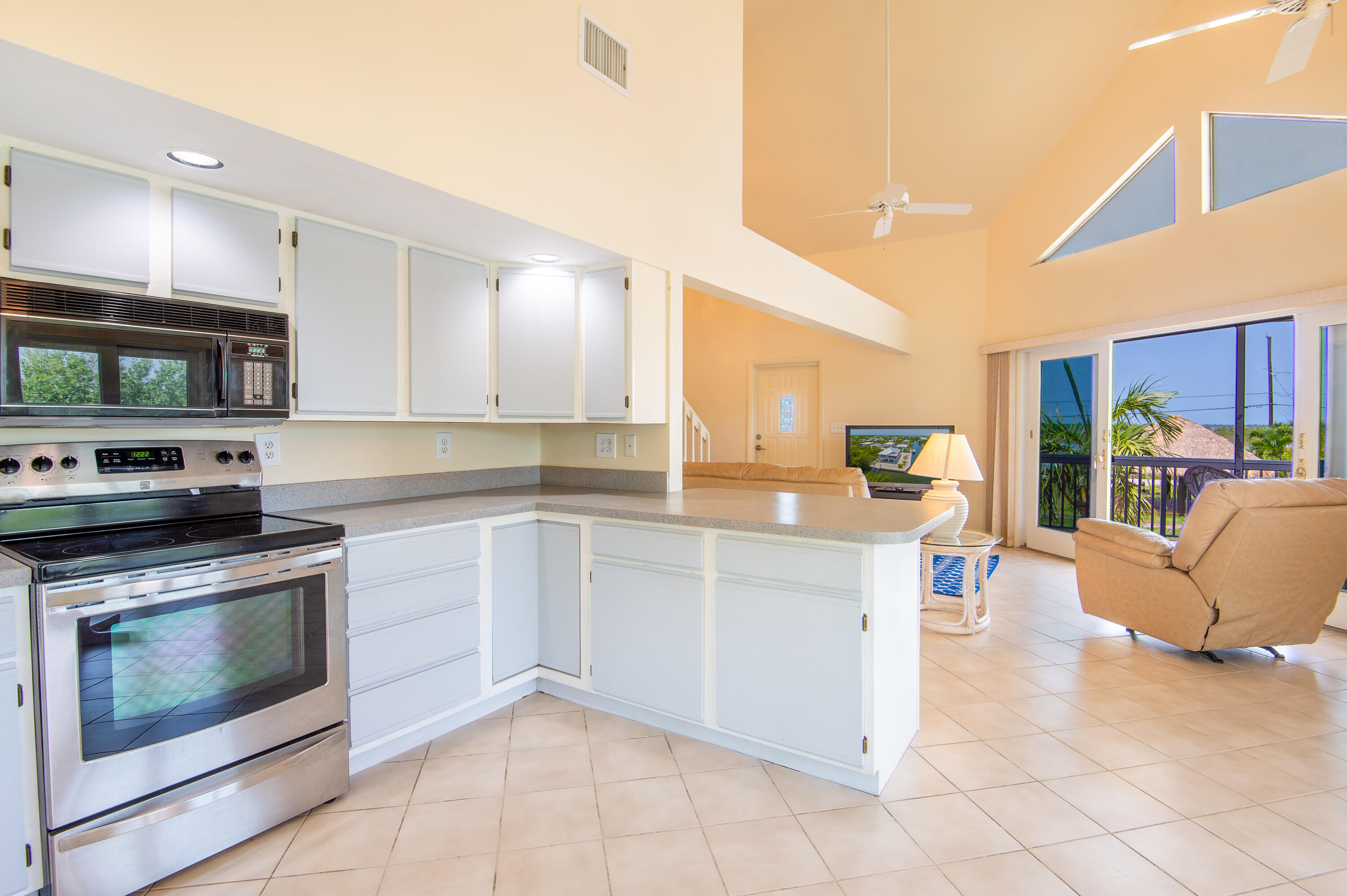 29015 Cedar Drive Big Pine Key, FL 33043 - Photo 8 of 38 a kitchen with stainless steel appliances granite countertop a stove and a sink