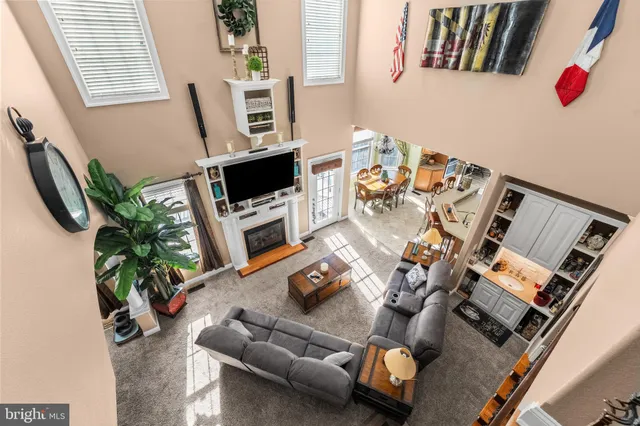a living room with furniture a flat screen tv and a potted plant