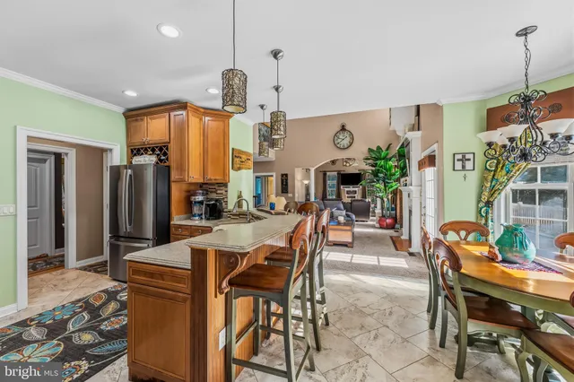 a kitchen with stainless steel appliances granite countertop a stove a sink and a refrigerator