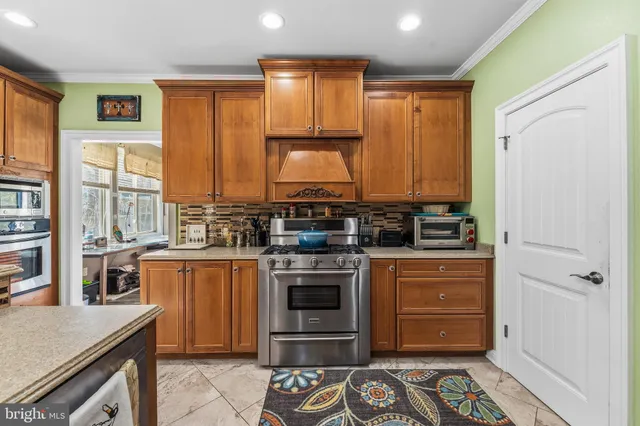 a living room with furniture a flat screen tv and a floor to ceiling window