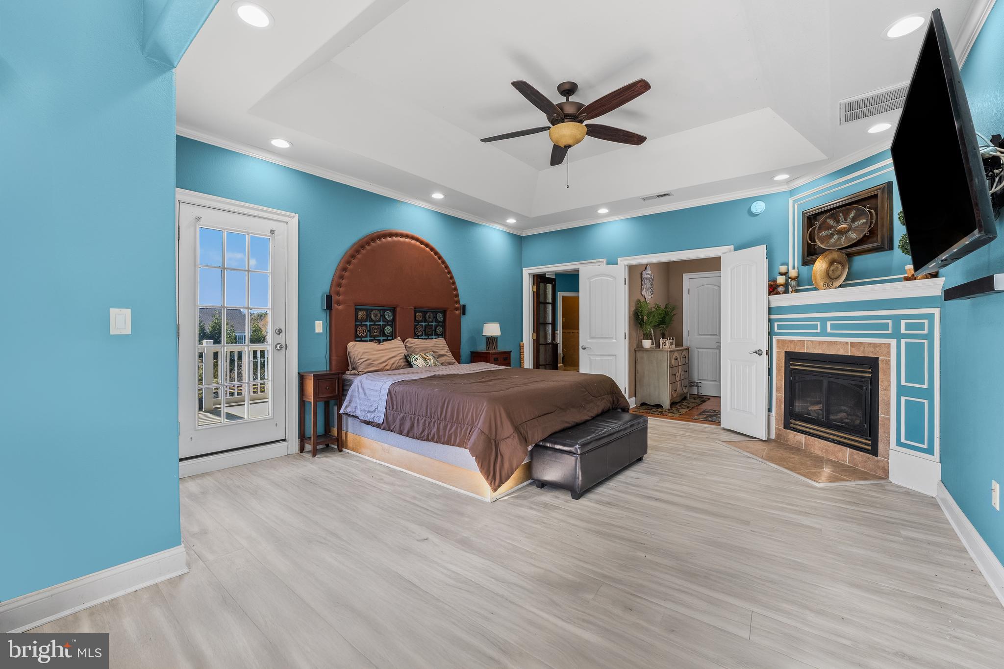 32383 Longridge Road Parsonsburg, MD 21849 - Photo 29 of 91 a spacious bedroom with a bed a flat screen tv and a fireplace