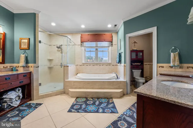 a kitchen with a refrigerator a sink and wooden floor