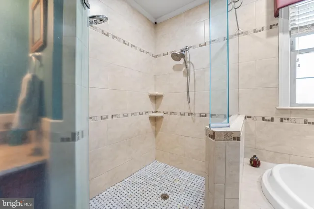 a living room with furniture a chandelier and a floor to ceiling window