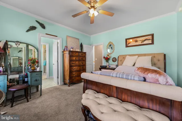 a view of a house with a yard and large trees