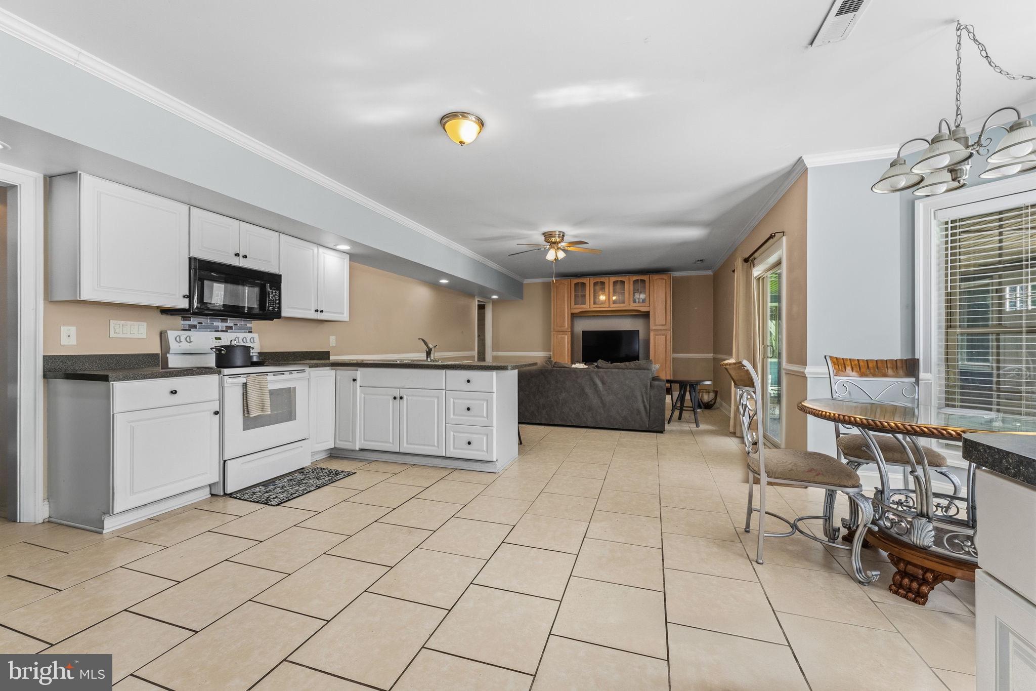 32383 Longridge Road Parsonsburg, MD 21849 - Photo 48 of 91 a large white kitchen with cabinets and a stove top oven