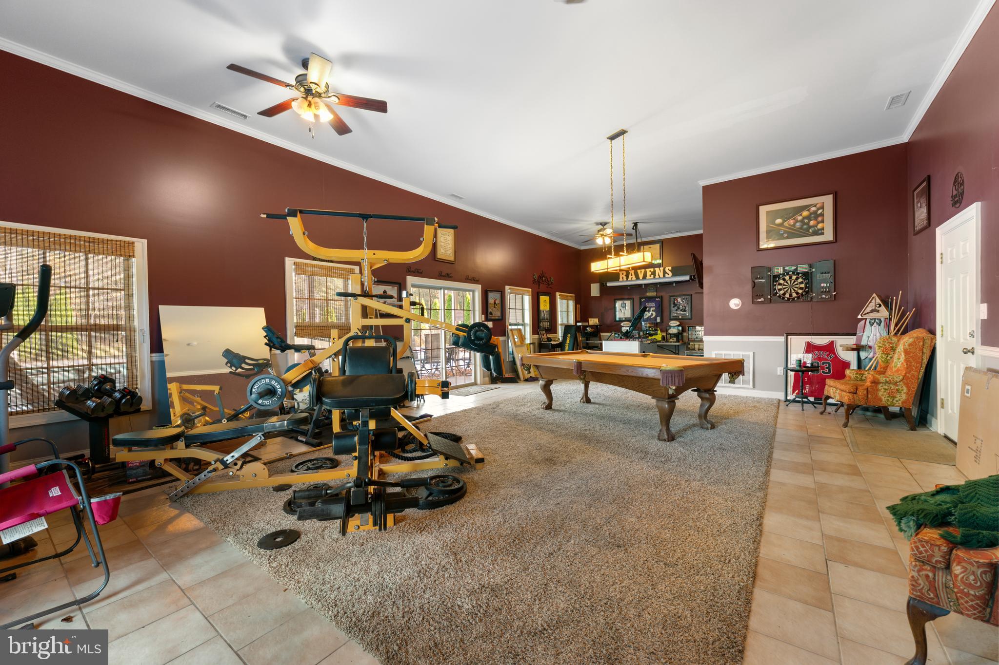 32383 Longridge Road Parsonsburg, MD 21849 - Photo 66 of 91 a living room with furniture a chandelier and a floor to ceiling window
