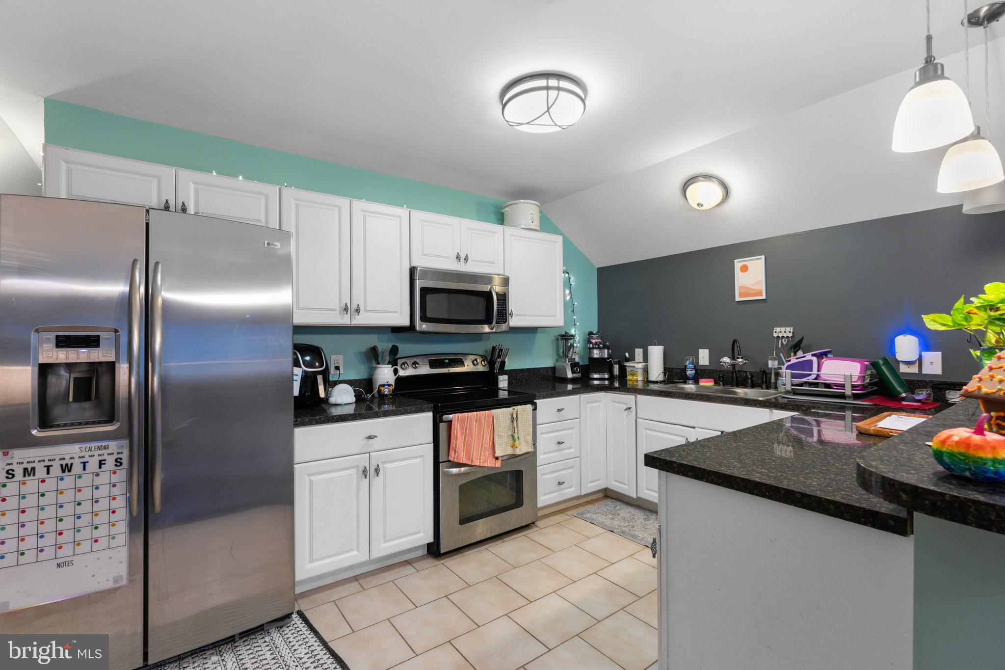 32383 Longridge Road Parsonsburg, MD 21849 - Photo 72 of 91 a kitchen with granite countertop a sink stainless steel appliances and counter space